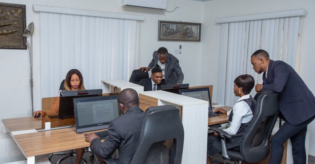 A group of professionals working together in a modern office setting, emphasizing teamwork and productivity.