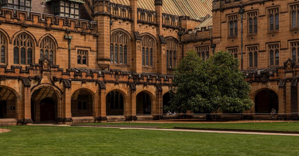 The iconic sandstone architecture of the University of Sydney Quadrangle on a clear day, a symbol of academic excellence.