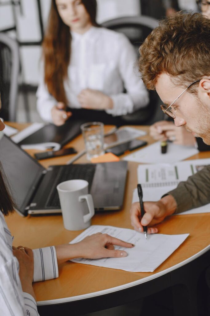 Professional team engaging in a collaborative office meeting, discussing documents and ideas.