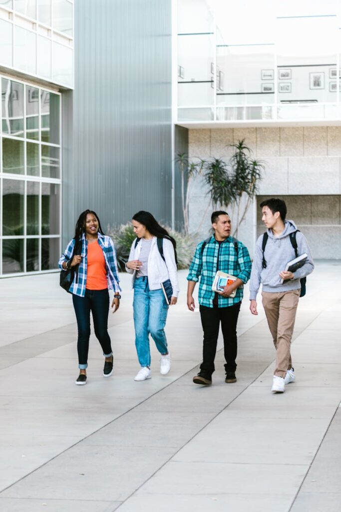 Tuition & Aid Group of diverse college students walking together on campus. Friendship and education concept.