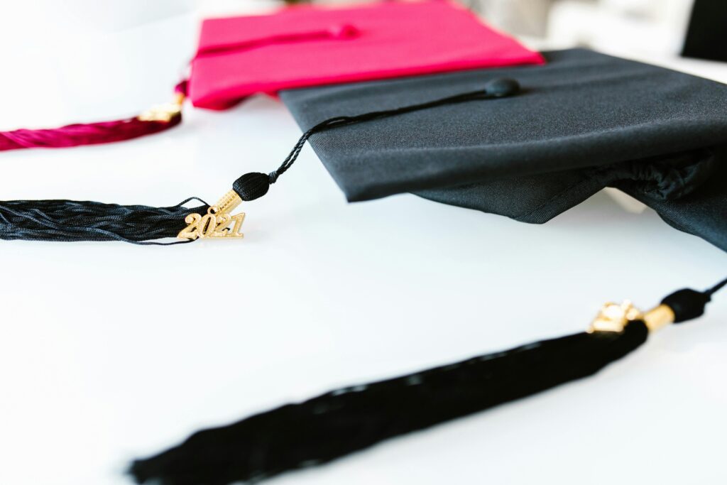 Tuition & Aid Graduation caps with tassels marked 2021, symbolizing academic achievement.