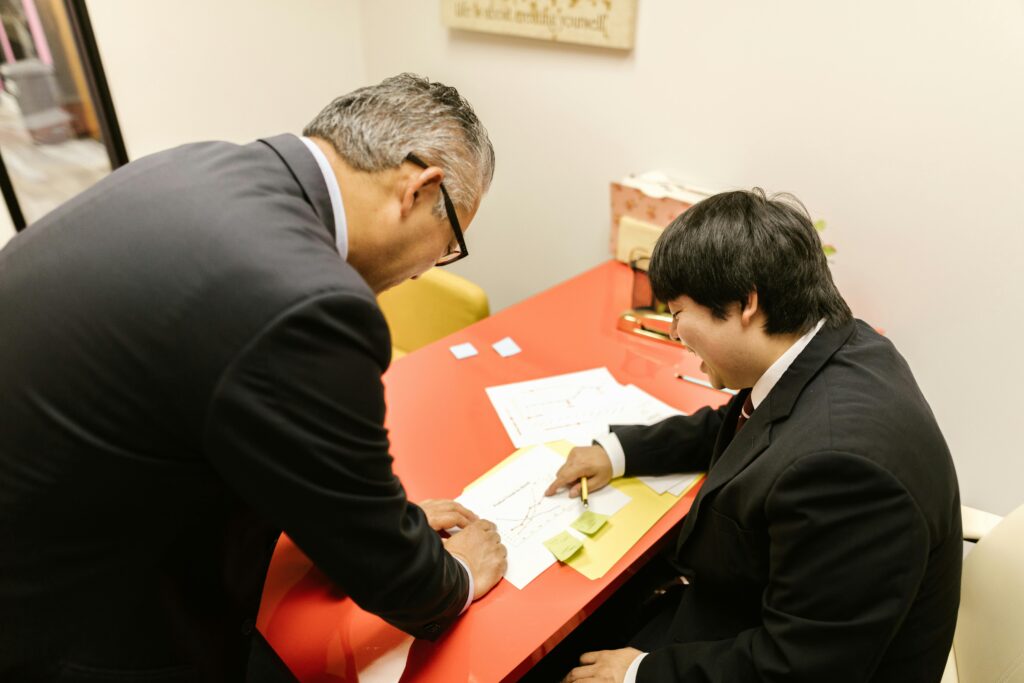 Two business professionals engaged in a collaborative discussion at an office table.