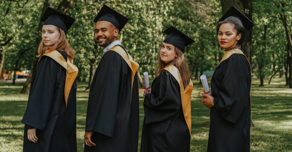 A celebratory group of diverse graduates wearing caps and gowns outdoors, holding diplomas.