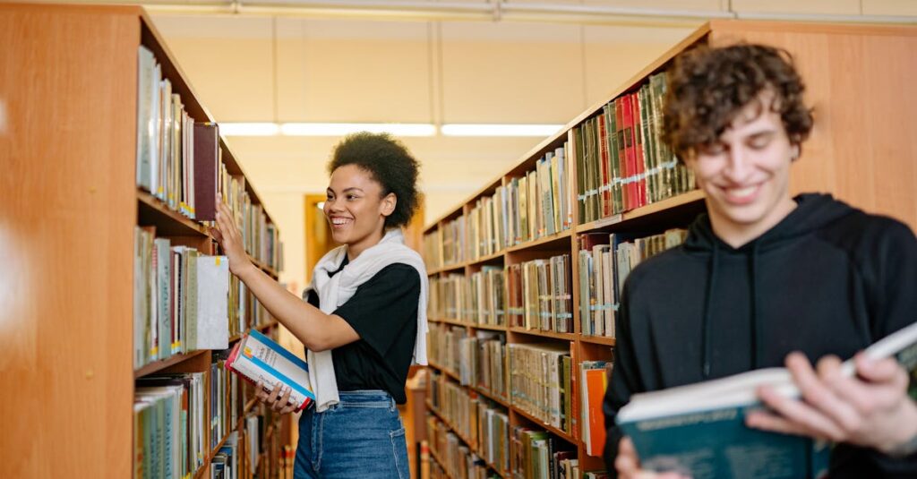 Two students studying in a university library, choosing books from shelves.
