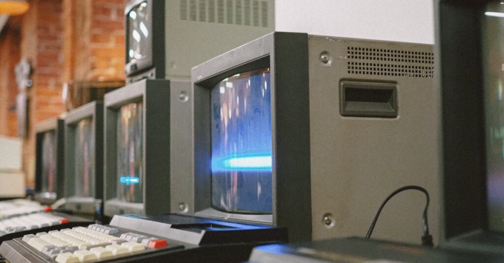 Row of vintage CRT computer monitors showcasing classic technology indoors.